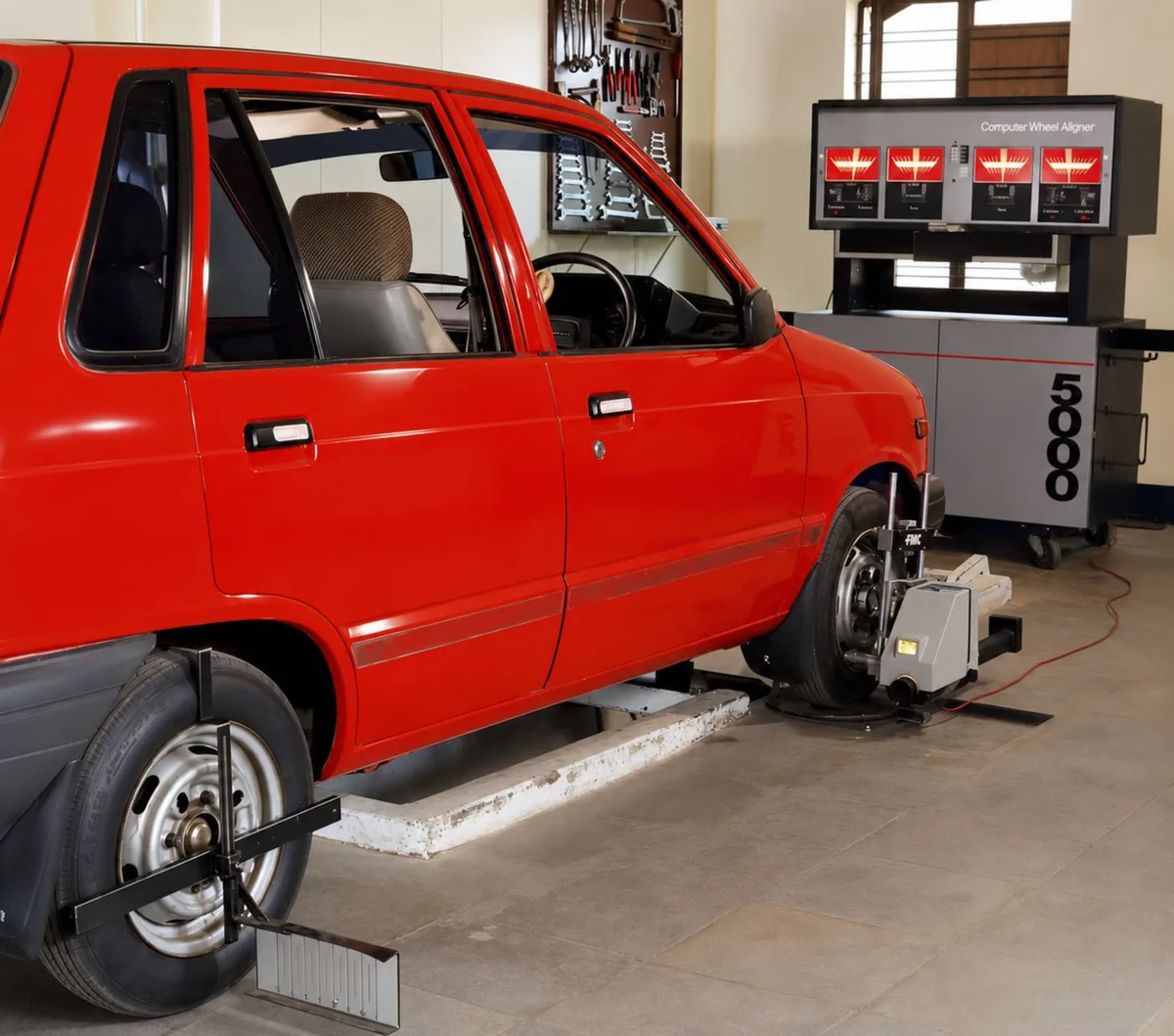 Quatro pneus de carro alinhados, mostrando as rodas completas